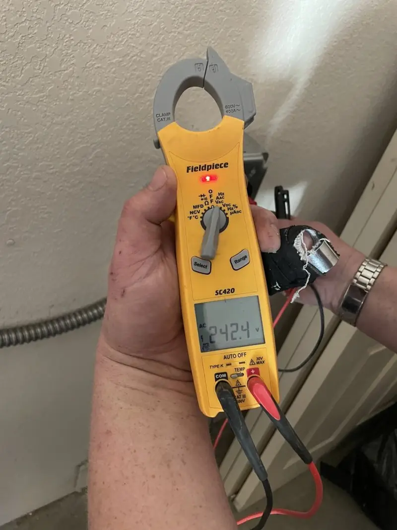 Voltage testing with clamp meter during Electrical Installation Services in Delhi Hills